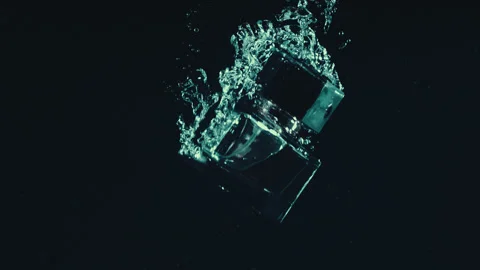 Glass object sinking in water in slow motion. Close up Video stock 266896348