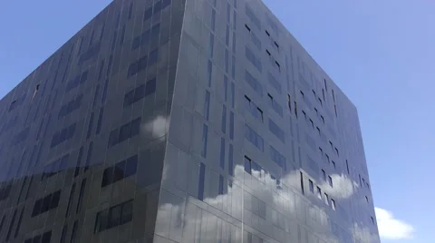 Glass office block reflected clouds deep blue sky Stock Footage 65375836