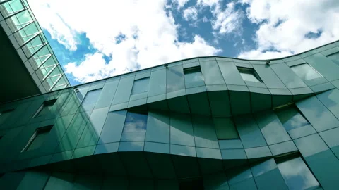 Glass office building, clouds in the background 4K. Time lapse. ProRes 422 HQ. Stock Footage 247919395