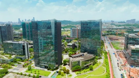 Glass office towers beside a developing road corridor in Guangzhou China Stock Footage 345957877