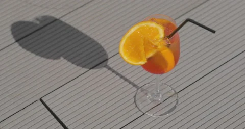A glass with an orange-colored Stock Footage 238844100