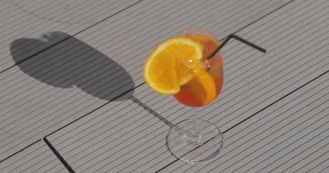 A glass with an orange-colored Stock-Footage 238844195