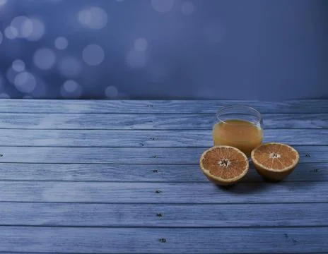 Glass of orange juice with split oranges Stock Photos