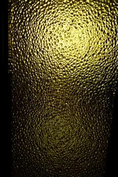 Glass panel reflects light creating abstract patterns with small triangles 库存照片