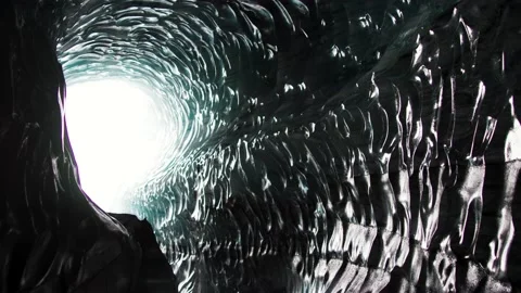 Glass pattern on Ice cave wall in Iceland with bright light at end of Stock Footage 238076206