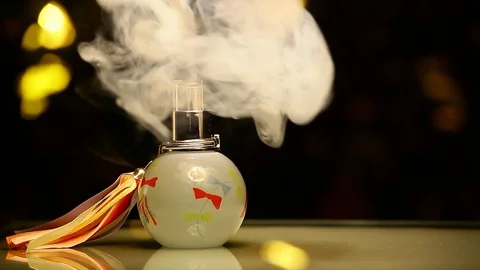 Glass perfume bottle smoke dark background Stock Footage 127790053
