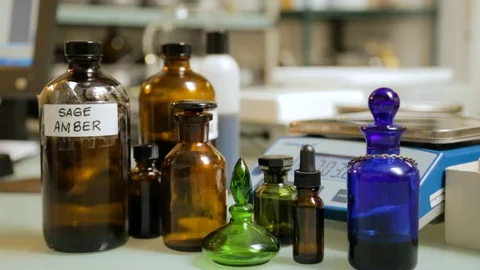 Glass perfume bottles of different shapes, sizes, and colors next to each Stock Footage 101888575