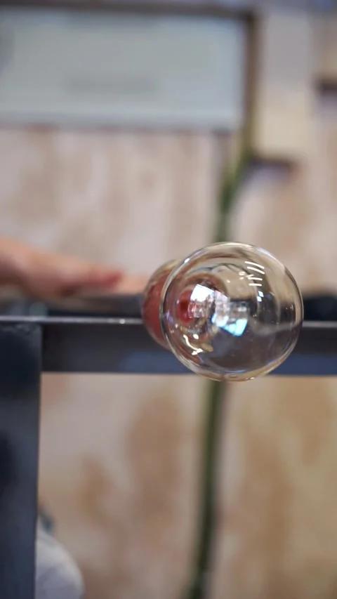 Glass piece in the process of artisanal creation through glass blowing Stock Footage 277410115
