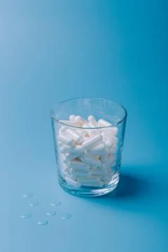 Glass with pills Stock Photos