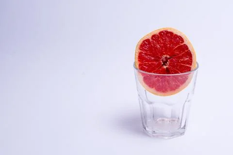 A glass of pink grapefruit on white background. Stock Photos