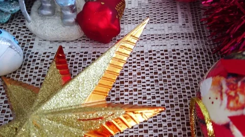 Glass plastic ceramic textile Christmas tree decoration on white lacy tablecloth Stock Footage 143961753