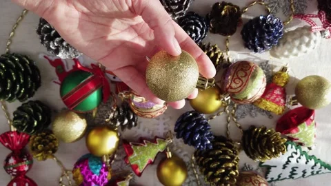 Glass, plastic, Christmas tree decorations on table. Womens hands. Close-up Stock Footage 144268635