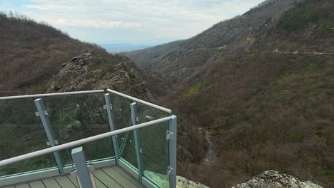 Glass platform overlooks deep, leafless valley. Vucjanka Canyon, Serbia Видео 332170151