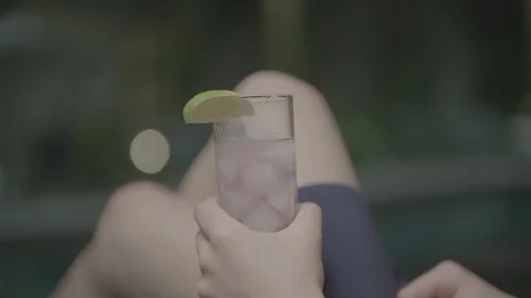 Glass at poolside at night Stock Footage 88614008