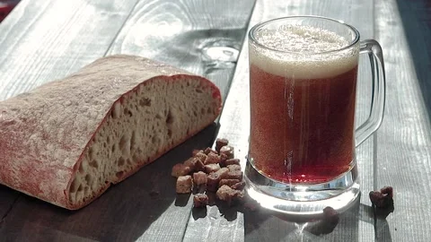 Glass pouring with kvas with bread and rye breadcrumbs Stock Footage 134883701