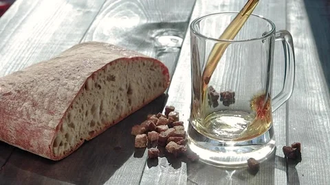 Glass pouring with kvas with bread and rye breadcrumbs Stock Footage 134883706