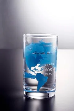 Glass with printed world map 스톡 사진