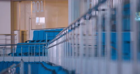 Glass railing with chrome poles between the lines of seats on the tribune  Stock Footage 119543047
