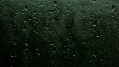 Glass with raindrops in a dramatic color Видео 132732878