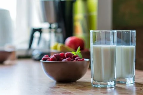 Glass of raspberry milk shake with berries on bright background Stock Photos