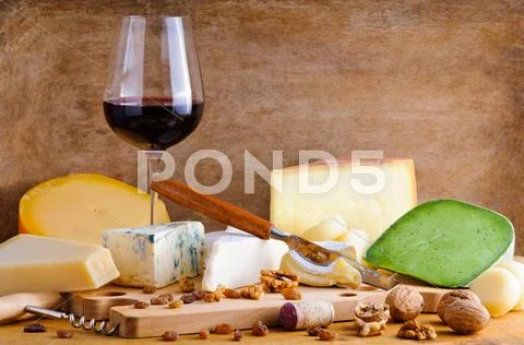 Glass of red wine and cheese plate Stock Photos