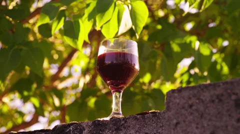 Glass of Red Wine on Block Wall Outside Stock Footage 35287492