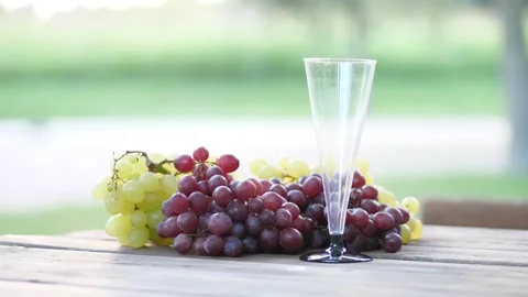 Glass of red wine with bunches of fresh grapes as a background 動画素材 137465053