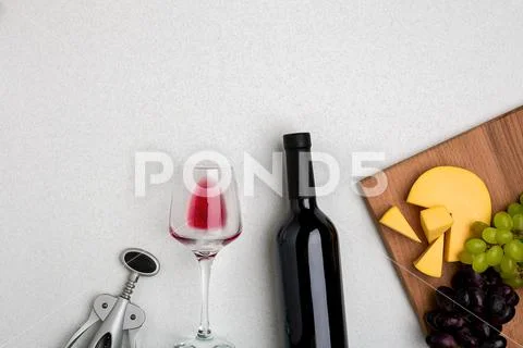 Glass of red wine, cheese and grapes. Top view Stock Photos