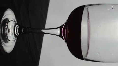 Glass with red wine close-up. Vertical video. Slow motion Video stock 146678451