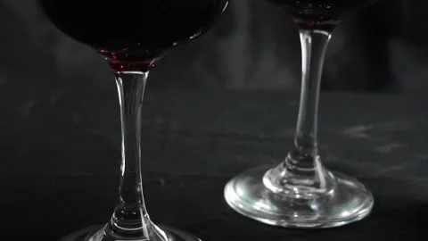 Glass of red wine on a dark background. Slow motion Vídeo Stock 163373944