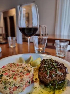 Glass of red wine with dinner Stock Photos