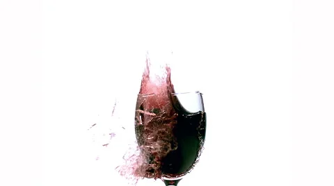 Glass of Red Wine Exploding and Splashing against White Background, Slow motion Stock Footage 67759314