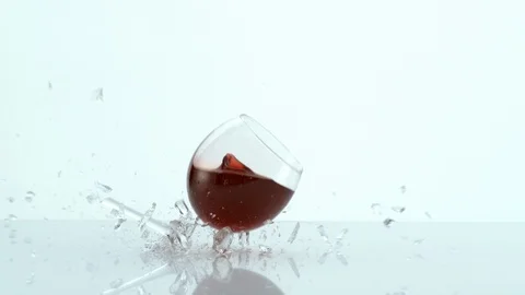 Glass of red wine falling and breaking in slow motion Stock Footage 106595103