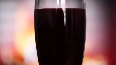 Glass of red wine in front of the fireplace Stock Footage 145709681