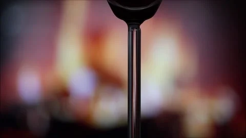 Glass of red wine in front of the fireplace Stock Footage 145709684