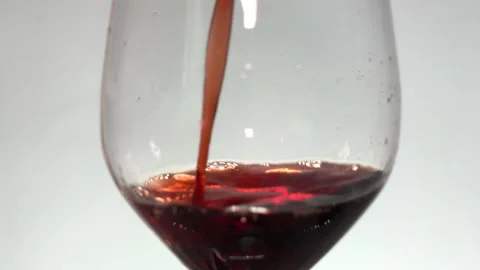 Glass with red wine splashes and splashes into the glass studio shot Video stock 251207488