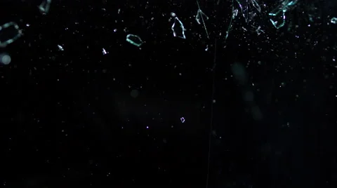 Glass shards on black, breaking over the camera in slow motion Video stock 63785271