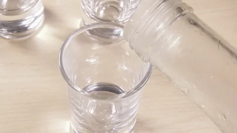 A glass shot on a light table and alcohol Stock Footage 91584562