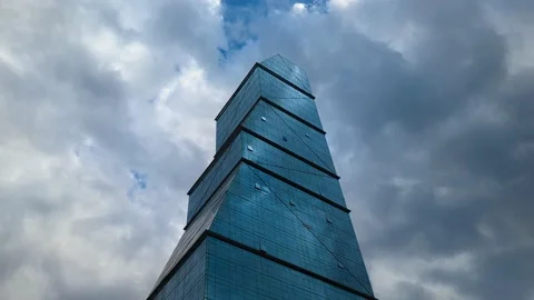 Glass skyscraper and clouds time-lapse Stock Footage 235984415