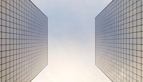 Glass skyscraper seen from below with a cloudy sky 写真素材