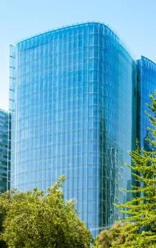 Glass skyscraper with trees Stock Photos