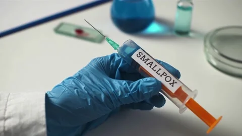 Glass slide with blood sample for monkeypox virus test. Test tube, flask wit Stock Footage 196979010