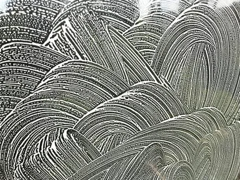 Glass with soapy pattern. Stock Photos