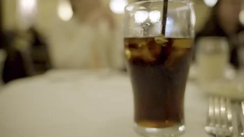 Glass of Soda with straw table close up pan right slow motion Cherry Hill NJ Stock Footage 274844428