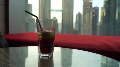 A glass of soft drink on the table with Kuala Lumpur city landmark background. Stock Footage 105327790