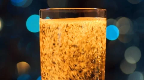 Glass of sparkling wine and color light in bokeh Stock Footage