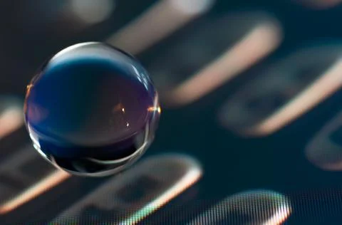 Glass sphere on screen Stock Photos