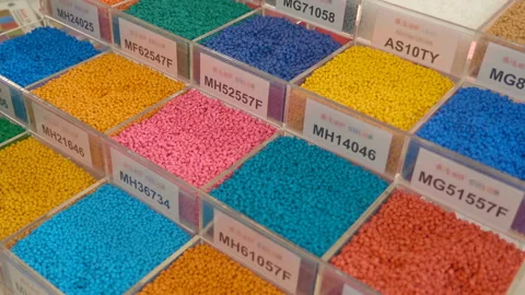 In glass square containers, samples of plastic granules of different colors  Video stock 187754077