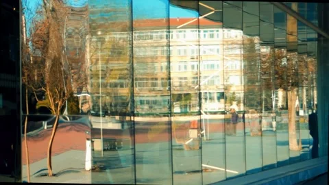 Glass storefront reflect the surrounding views. Tall glass windows along the Stock Footage 304878026
