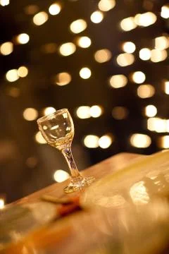 Glass on the table with lights Stock Photos
